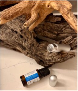 Mieszanka Stress Less w inhalatorze na tle korzenia drzewa – aromaterapia na stres i mindfulness